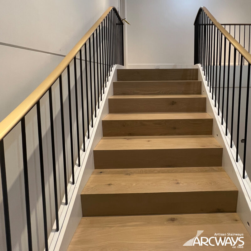Modern Curved Staircase with Bronze Handrail