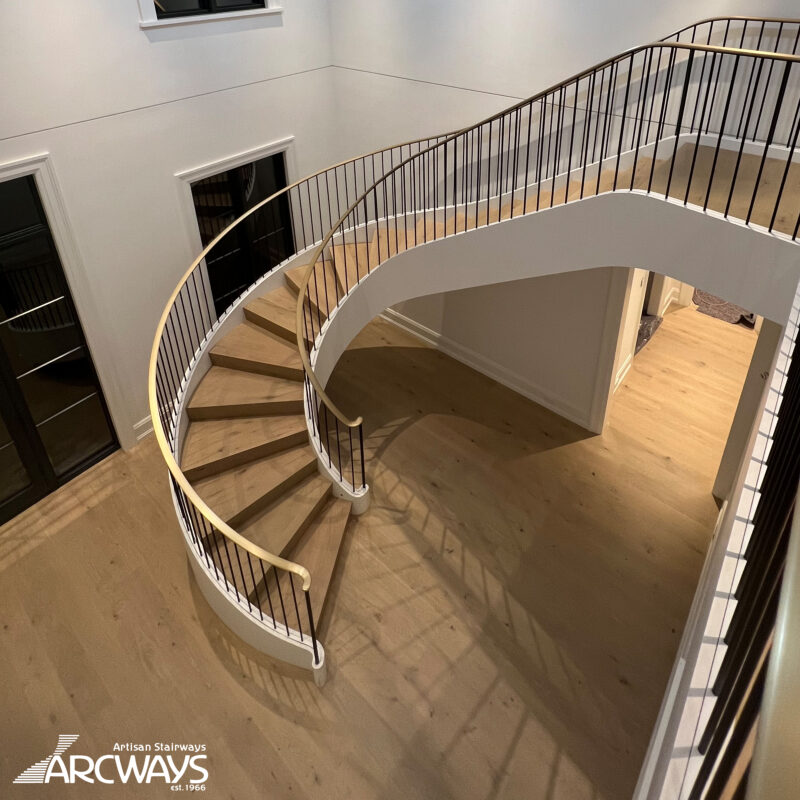 Modern Curved Staircase Design with Bronze Handrail