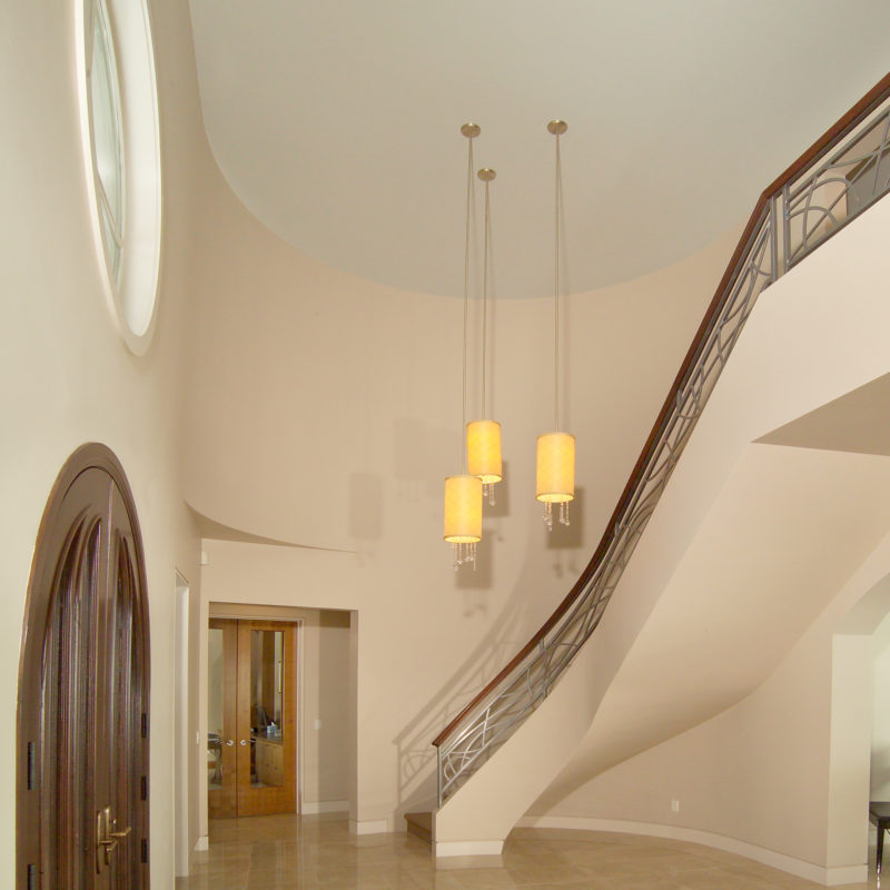 Modern Curved Stairway and Balcony with Custom Metal Baluster and Integrated Lighting