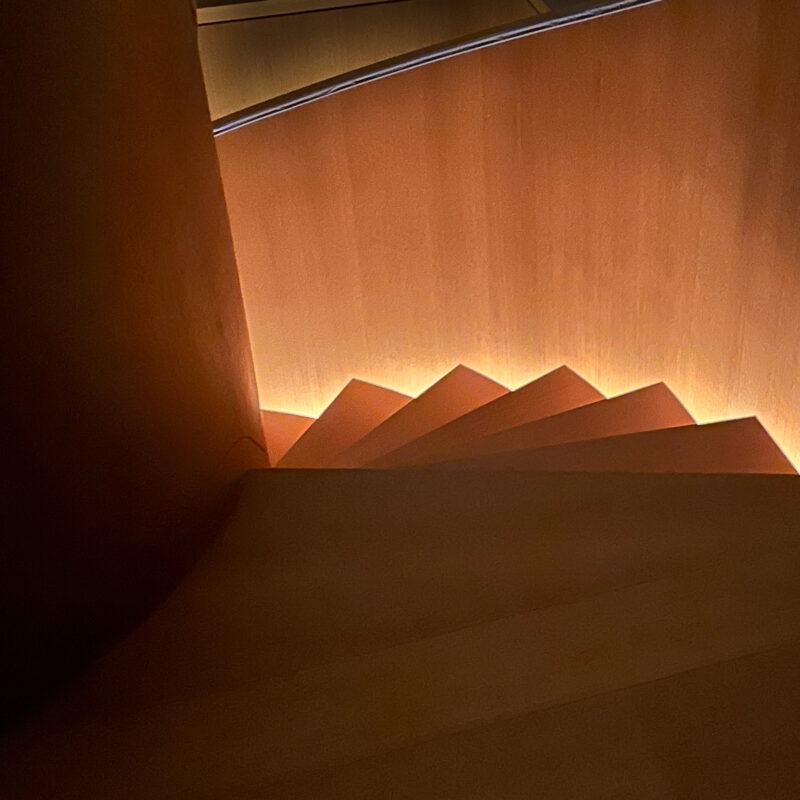 Modern Helical Wood Stair with Parapet Wall and Integrated Lighting