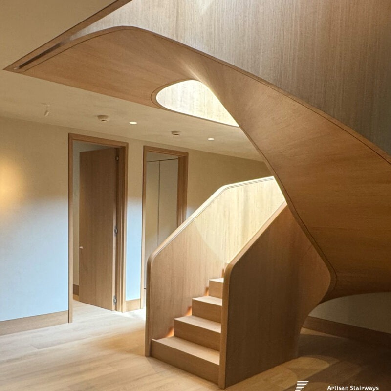 Modern Helical Wood Stair with Parapet Wall and Integrated Lighting
