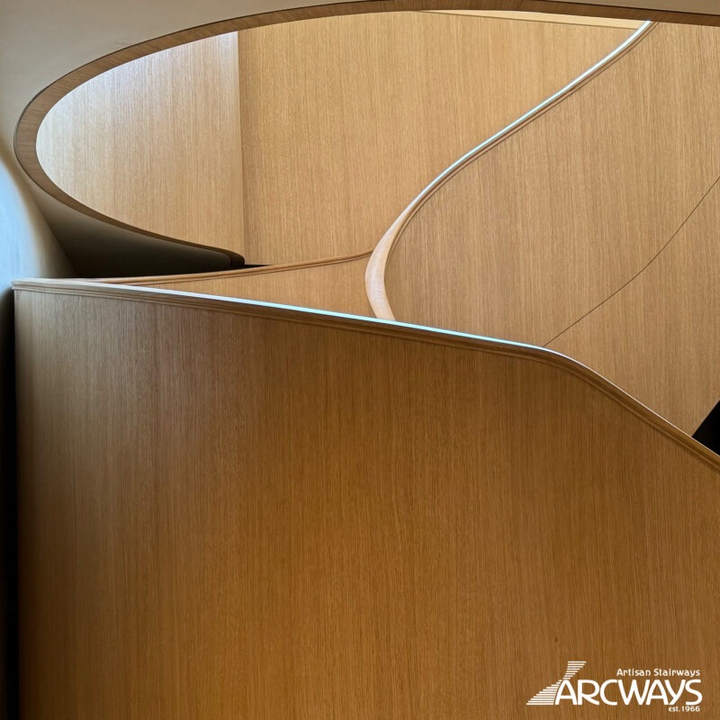 Modern Helical Wood Stair with Parapet Wall and Integrated Lighting