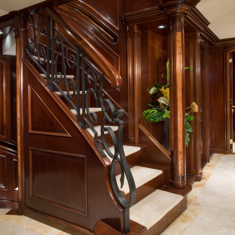 Classical Curved Stair with Custom Millwork and Iron Balustrade in Motor Yacht