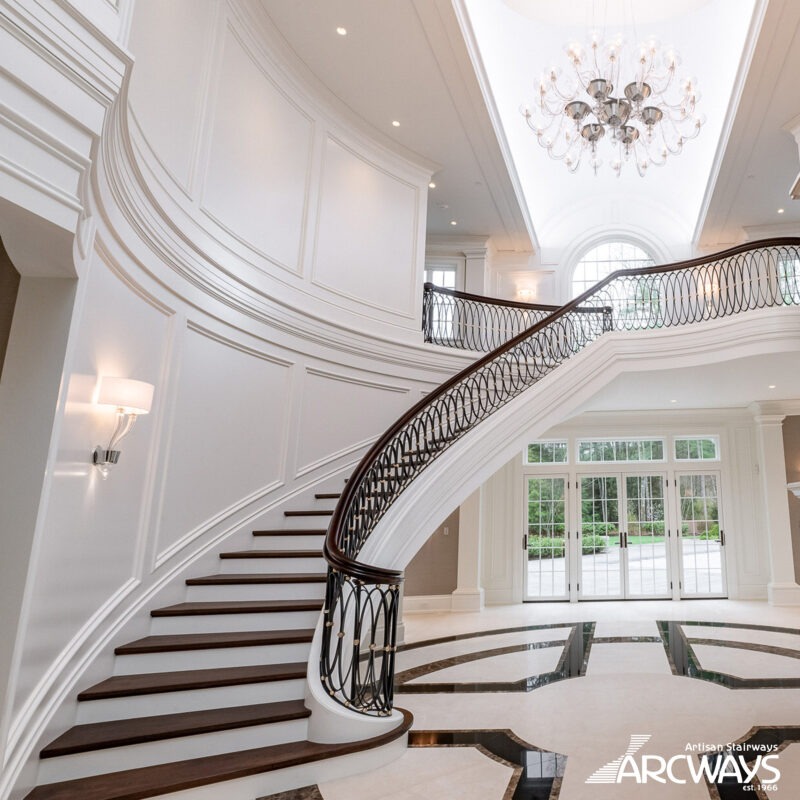 Custom Classic Curved Staircase with Forged Iron and Mahogany Rail